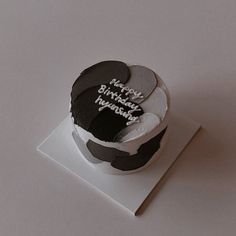 a birthday cake with black and white frosting