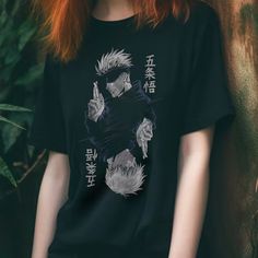 a woman with red hair wearing a black t - shirt that has anime characters on it