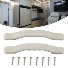 the interior of a camper with white furniture and screwdrivers in front of it