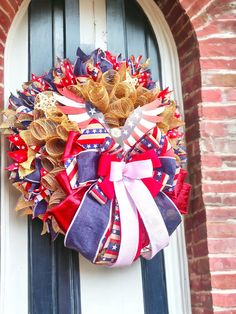 a patriotic wreath is hanging on the front door