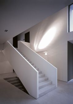 an empty room with stairs leading up to the second floor