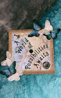 there are three butterflies on top of a map with the words, world is a beautiful place