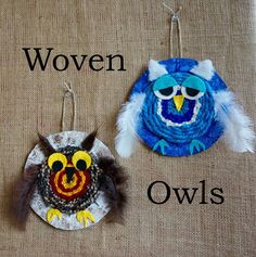 two ornaments are hanging on the wall next to each other, one with an owl and another with a bird's head