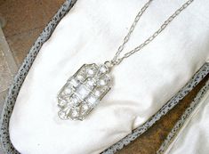 "Offering a stunning vintage Art Deco/Edwardian style pave crystal rhinestone pendant necklace. The geometric open work ornate silver rhodium plated pendant features square and baguette cut as well as round cut brilliantly clear sparkly pave set crystal rhinestones. I love the 1920s design of this one. I've hung the gorgeous pendant from the perfect dainty platinum toned SO Art Deco chain that fastens with a ring clasp. I've added an extra ring to the chain for versatility in length worn. It can Art Deco Diamond White Necklace For Wedding, Diamond White Art Deco Necklace For Wedding, Victorian Wedding Necklaces With Diamond Accents, Vintage Diamond White Necklace For Wedding, Art Deco Crystal Necklace For Wedding, 1920s Design, Vintage Wedding Jewelry, Vintage Rhinestone Jewelry, Edwardian Style