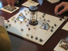 several people playing a board game on a table