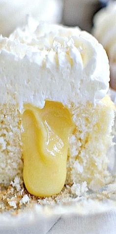 a piece of cake with white frosting and yellow icing on the top is sitting on a plate