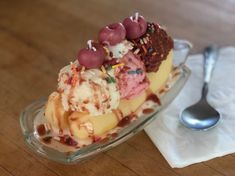 an ice cream sundae with sprinkles and toppings in a glass dish