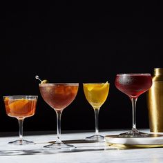 four different types of cocktails lined up on a table