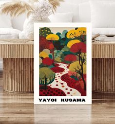 a card with the words yayoi kusama on it in front of a couch