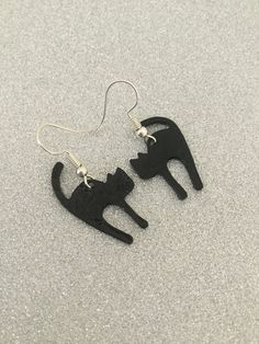 Black cat earrings. 27mm adorable black enamel painted zinc alloy cats fitted with 20mm zinc alloy hypoallergenic fish hook earring wires. Lead and nickel free. These sweet earrings will make a very special gift for any animal loving lady or a wonderful treat for yourself. Shipped in a pretty satin gift bag. Estimated shipping times - Business days : North America 5-15 Europe 5-15 Australia / New Zealand  7-21 United Kingdom  1-3 Please note that due to brexit, some overseas orders are subject to customs delays at the destination. Black Cat Earrings, Sweet Earrings, Earring Wires, Animal Earrings, Fish Hook Earrings, Cat Jewelry, Cat Lover Gift, Cat Earrings, Animal Jewelry