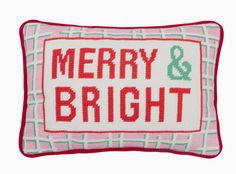 a red and white pillow with merry and bright on it