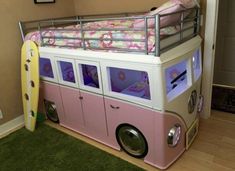 a pink and white bunk bed with a surfboard