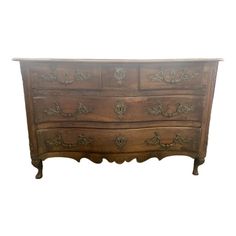 an old wooden dresser with ornate carvings on the top and bottom, against a white background