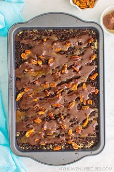 a pan filled with chocolate and nuts on top of a table