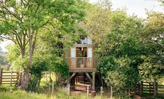 a tree house in the middle of some trees