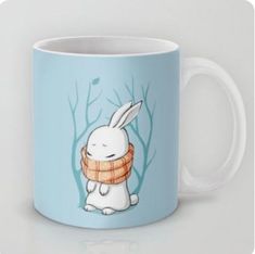 a coffee mug with an image of a white rabbit wearing a scarf around its neck