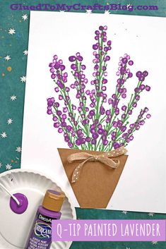 a paper plate with purple flowers on it next to a crafting kit and glue