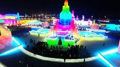 people are standing around in front of illuminated buildings