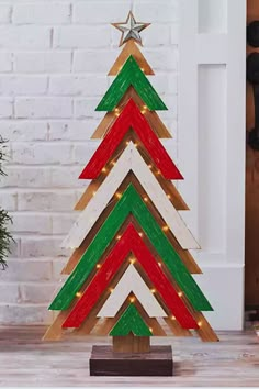 a wooden christmas tree with lights on it