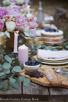 the table is set with flowers and candles