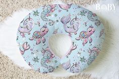 an inflatable baby seat cover with unicorns and stars on it sitting on the floor