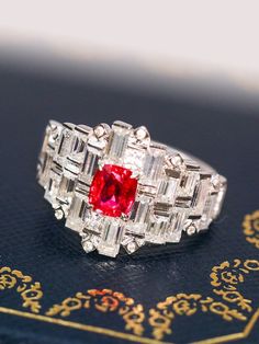 •Condition: Brand new•Center Stone: Natural Peach Red Spinel from Burma, Cushion Cut, 0.61ct•Side stones: Natural white diamond round-cut (VS1 clarity and F color)Natural white sapphire baguette-cut•Ring size: 4.05g (depend on the ring size)•Metal Purity: Optional Each piece is made-to-order with care and special attention to detail. all items are made with conflict-free diamonds and gems.Size: made to orderThe item will be gift wrapped and shipped.----------------------------------------------- Fine Jewelry Red Diamond Ring With Rose Cut, Heirloom Red Diamond Ring With 17 Jewels, Red Ruby Diamond Multi-stone Ring, Red Ruby Multi-stone Ring With Diamonds, Red Cluster Ring With 17 Jewels For Wedding, Luxury Red Cluster Ring With Center Stone, Luxury Red Ruby Cluster Ring, Red Ruby Ring With Baguette Cut Center Stone, Red Diamond Cluster Ring With Brilliant Cut