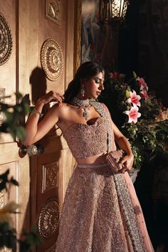 Pakistani Bridal Dress in Pink Lehenga and Choli Style has a perfect balance of style and elegance. This stunning Bridal Lehenga Choli is a trendy masterpiece adorned with Embroidery and hand-crafted details of embellishments, making it an epitome of beauty and grace. Lehenga Choli: The choli is in an alluring pink color is heavily embellished with intricate designs, zardosi, dabka, and silverwork. The shimmering details and lavish embroidery on the choli make it a perfect choice to pair with Lehenga. The choli has no sleeves which give this attire a modern look. Bridal Lehenga: This Bridal Lehenga comes in premium silk fabric and is emblazoned with the intricate dabka, kora, shimmering silver work, and tilla. Sequins, motifs, zardosi, and Resham make this Lehenga an epitome of beauty. The Lavender Bridal Lehenga, Choli Style, Bridal Lehenga Pakistani, Modern Lehenga, Pakistani Bridal Lehenga, Wedding Dresses Pakistani, Bridal Mehndi Dresses, Pakistani Bridal Dress, Walima Dress