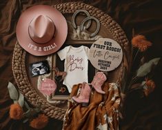 a baby's first rodeo outfit, hat, booties and other items laid out on a blanket