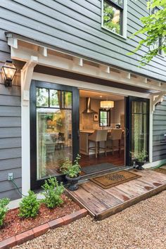 an outside view of a house that has a patio and dining room in it,