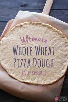 a person holding a piece of bread with the words ultimate whole wheat pizza dough on it