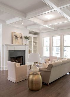 a living room filled with furniture and a fire place in the middle of a room