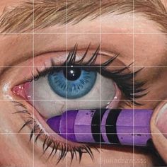 a close up of a person's eye with purple and black pencils in front of them