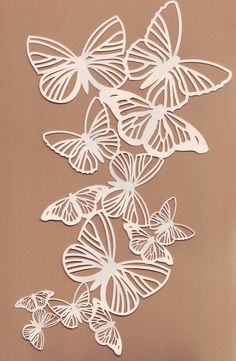 some white butterflies on a brown background