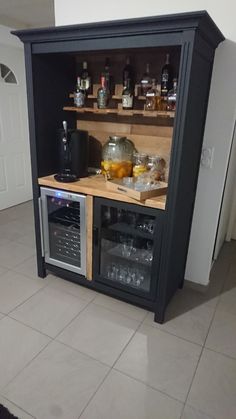 a kitchen with an oven, counter and wine rack in the corner on the floor