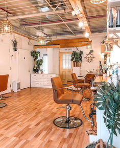 a salon with wooden floors and lots of chairs