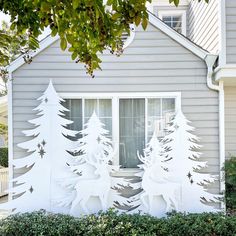 a white house with trees cut out of it