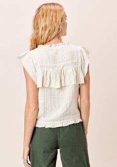 The prettiest bohemian-chic top in multi-textured cotton. Featuring delicate lattice trim inserts, a high neckline, and flirty ruffle details throughout. Flattering and unique, this boho top looks great alone or layered under your favorite cardigan. FINAL SALE Relaxed fit Ruffled cap sleeve Cropped length High ruffled neckline Button front Ruffle details Lattice trim inserts Model is 5'9, wearing a size S.Style: I-12531W-QSD Feminine Cotton Tops With Crochet Trim, Bohemian Top With Ruffled Collar, Bohemian Ruffle Sleeve Tops For Spring, Spring Top With Lace Trim And Ruffled Collar, Summer Cotton Peasant Top With Ruffle Hem, Spring Cotton Peasant Top With Ruffles, Cotton Peasant Top With Ruffle Hem For Summer, Bohemian Sleeveless Top With Ruffle Hem, Bohemian Ruffled Collar Top For Summer