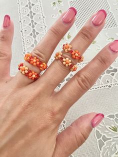 Sizing (approx.): US 5 = 50 mm US 6 = 51.8-52.5 mm US  7 = 54.3-55 mm US 8 = 56.9-57.5 mm Handmade from glass seed beads and elastic string. Knots may be visible on the underside of bracelet/ring.  If you would like to request size or color customization, please let me know through a customize note. Each item is handmade to order, therefore, returns and exchanges are not accepted but please feel free to message if there are any issues. However, I gladly accept cancellations if made within 2 hour Daisy Bead Ring, Flower Bead Ring, Beaded Flower Ring, Seed Bead Rings, Seed Bead Ring, Daisy Ring, Ring Flower, Bracelet Ring, Beaded Rings