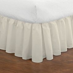 a white bed skirt with ruffles on it's bottom and bottom edge