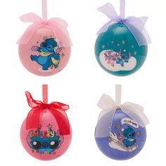 four ornaments with different designs on them in various colors and sizes, including blue, pink, green, purple