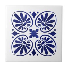 a blue and white tile with an ornate design in the center, on a white background