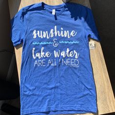 Cute And Simple Lake Life Tee Perfect For Summer Trips Blue Slogan T-shirt For Summer, Trendy Blue Pre-shrunk T-shirt, Light Blue Summer T-shirt For Everyday, Blue Short Sleeve Slogan T-shirt, Fun Blue T-shirt With Slogan, Light Blue Summer T-shirt With Letter Print, Blue Pre-shrunk T-shirt For Everyday, Light Blue Letter Print T-shirt For Spring, Fun Blue Tops With Slogan