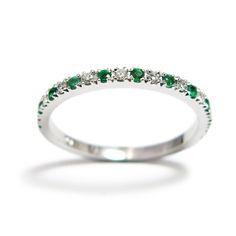 a white gold ring with emeralds and diamonds