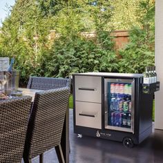 a beverage cooler sitting on top of a patio next to a table