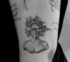 a woman's arm with tattoos and writing on the back of her head, in black and white