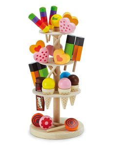 a wooden toy tower filled with lots of different types of candies and ice cream