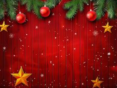 christmas background with fir branches and red baubles on wooden planks, stars and snowflakes