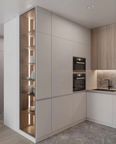 a modern kitchen with an oven, sink and cabinets in beige tones is seen here