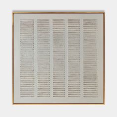 a white and gold framed artwork with wooden slats on the bottom half of it