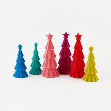 a row of brightly colored christmas trees against a white background